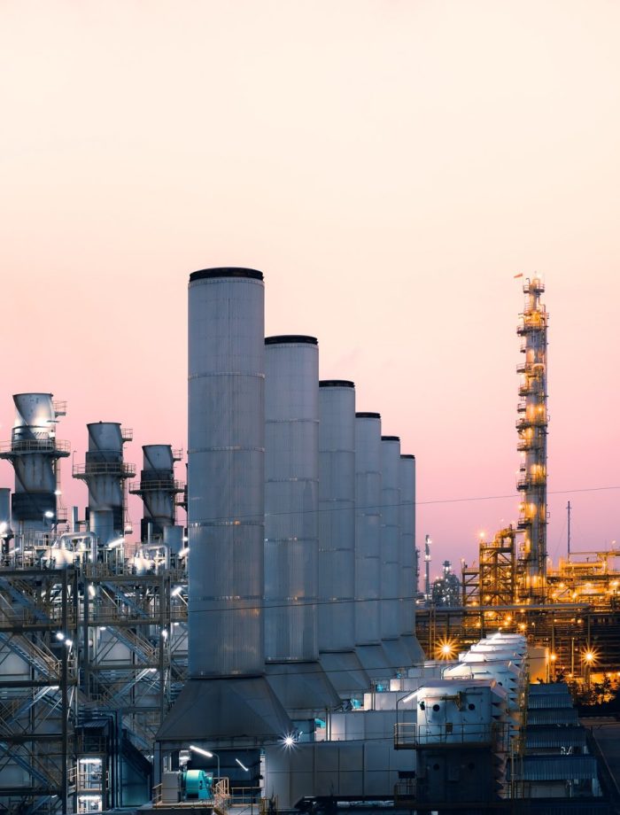 Factory of oil and gas refinery industrial plant with sunrise sky background, petrochemical industry, Smoke stacks of power plant